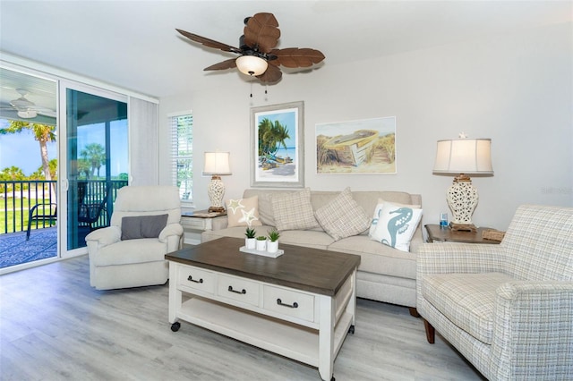 living room featuring light hardwood / wood-style flooring and ceiling fan