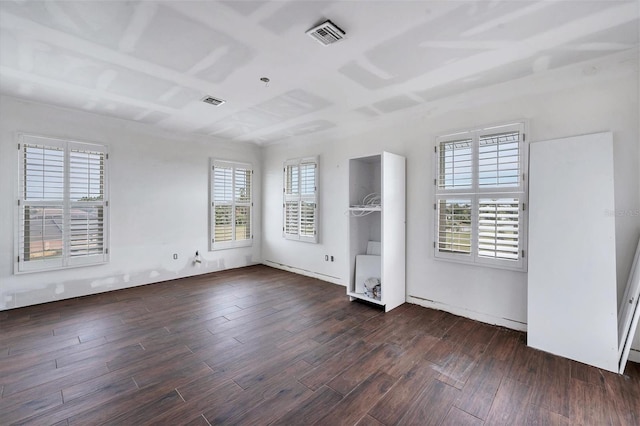 unfurnished bedroom with multiple windows and dark hardwood / wood-style floors