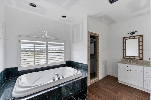 bathroom featuring vanity, hardwood / wood-style flooring, and independent shower and bath