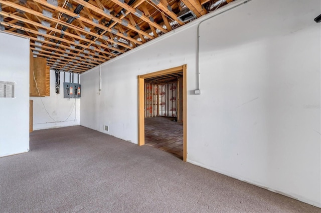 basement with electric panel and carpet flooring