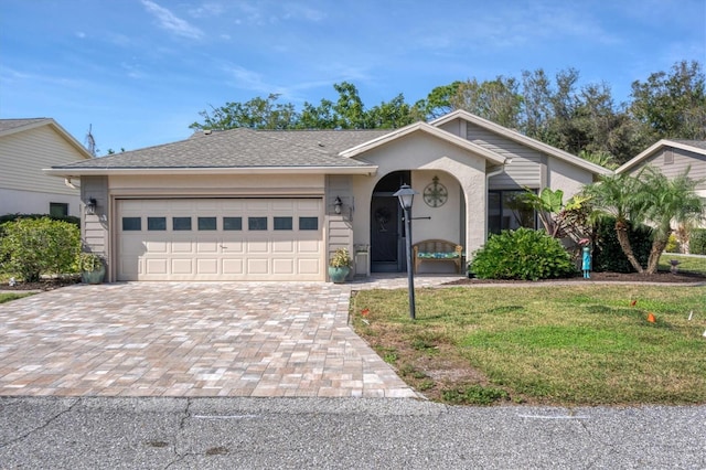 ranch-style house with a front lawn and a garage