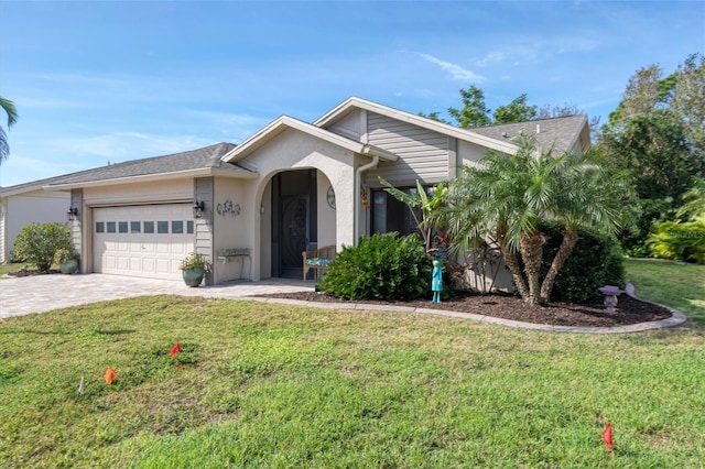 single story home with a front yard and a garage