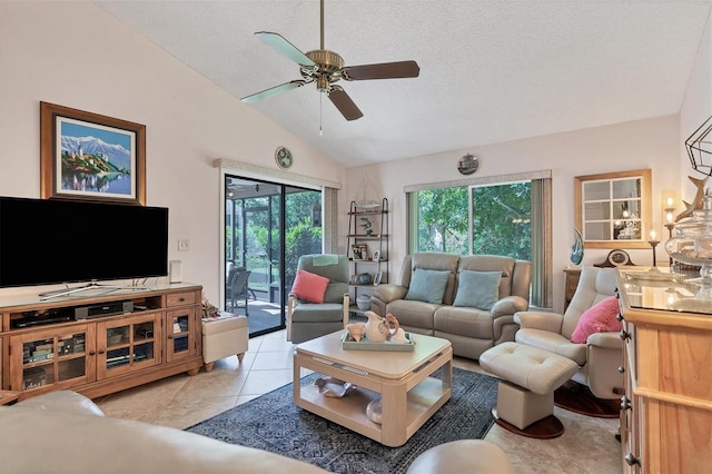 tiled living room featuring vaulted ceiling, a textured ceiling, a healthy amount of sunlight, and ceiling fan