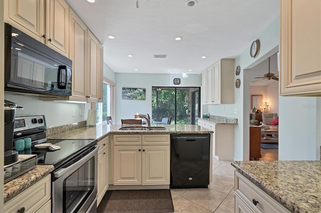 kitchen featuring light stone countertops, ceiling fan, black appliances, sink, and light tile floors