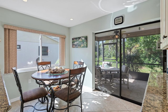 tiled dining area with ceiling fan