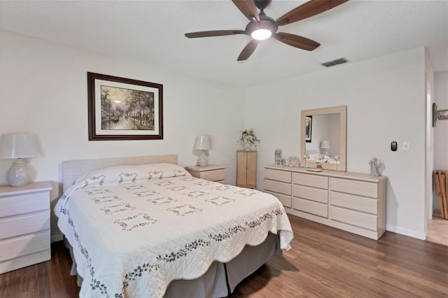 bedroom with ceiling fan and dark wood-type flooring