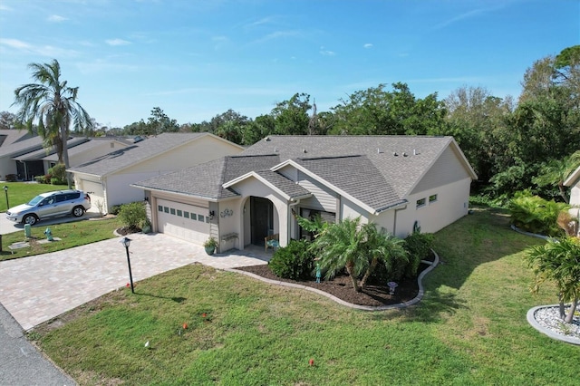 ranch-style house featuring a front lawn and a garage