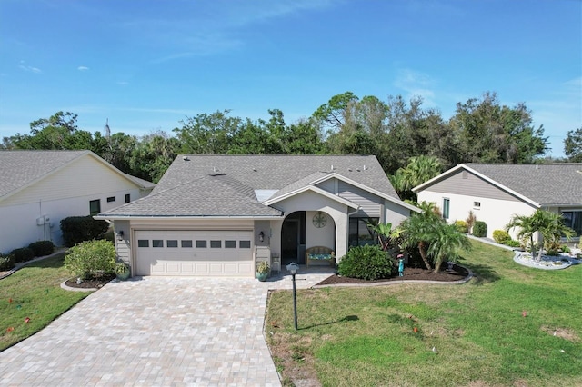 ranch-style house featuring a front yard and a garage