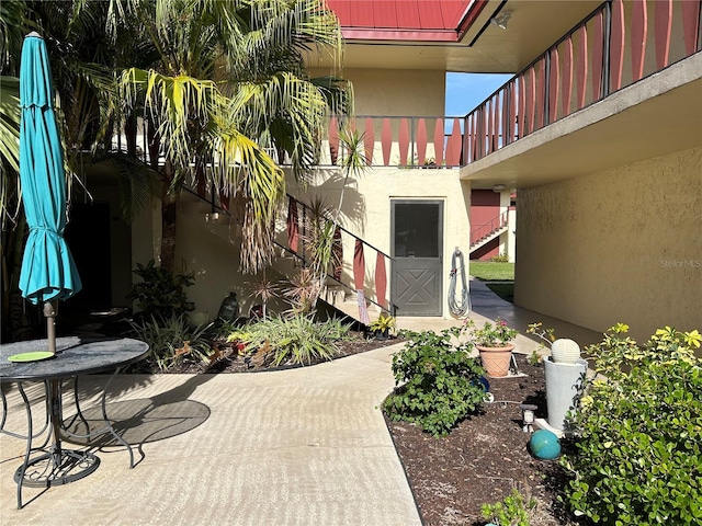 view of patio featuring a balcony