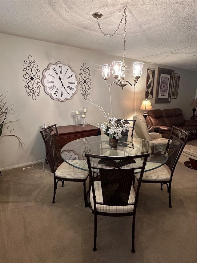 dining area with a notable chandelier, carpet floors, and a textured ceiling