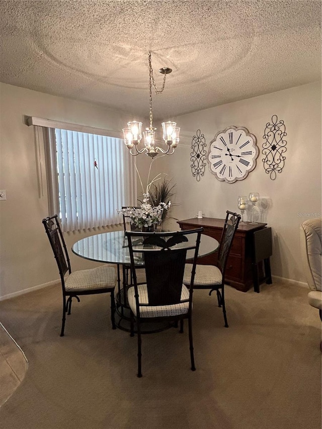 dining area with a textured ceiling, a chandelier, and carpet flooring