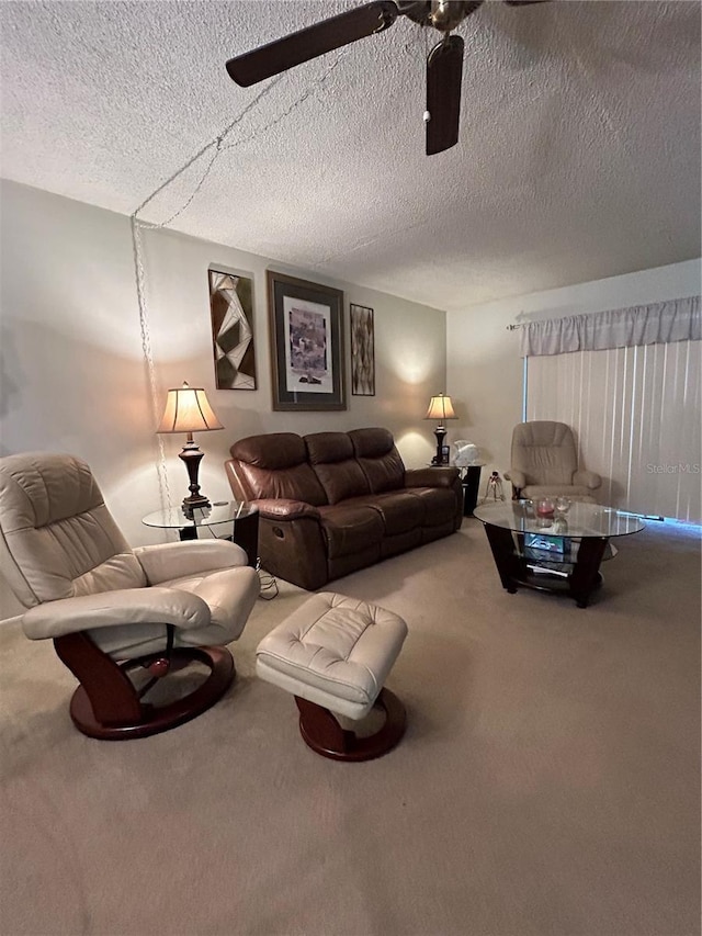 living room featuring carpet, a textured ceiling, and ceiling fan