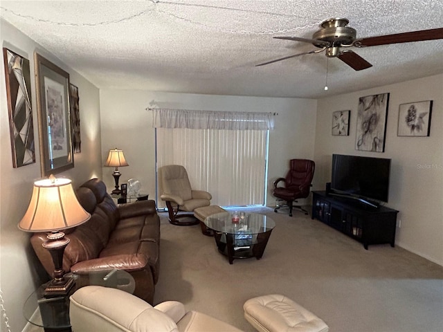 carpeted living room featuring ceiling fan and a textured ceiling