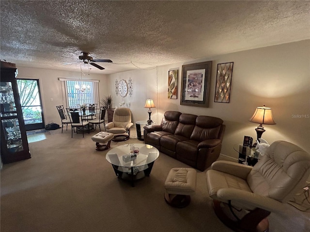 carpeted living room with ceiling fan with notable chandelier and a textured ceiling