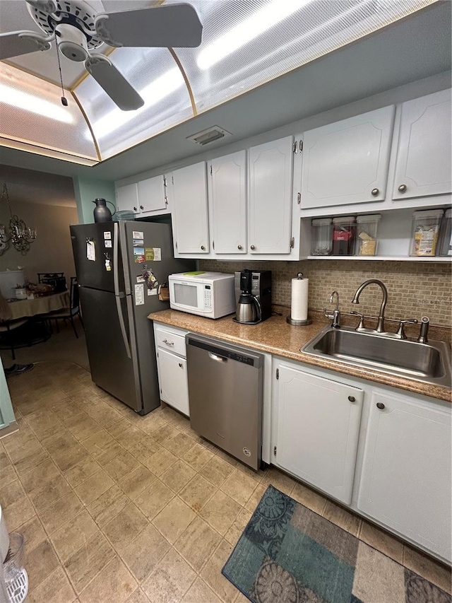 kitchen featuring sink, ceiling fan, white cabinets, and appliances with stainless steel finishes