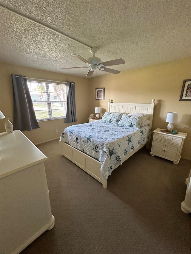 carpeted bedroom with ceiling fan and a textured ceiling