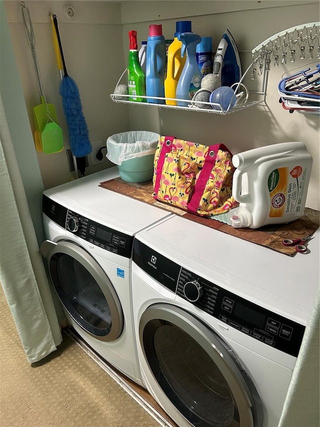 clothes washing area featuring separate washer and dryer