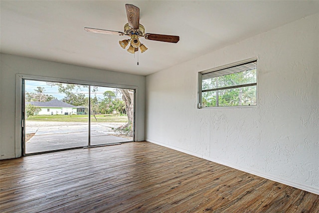 unfurnished room with ceiling fan and dark hardwood / wood-style flooring