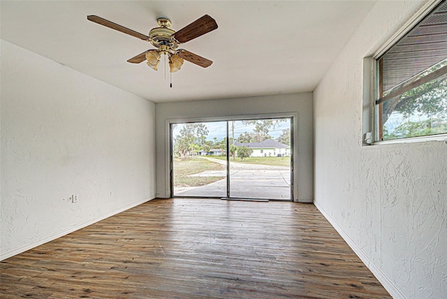 spare room with ceiling fan and dark hardwood / wood-style floors