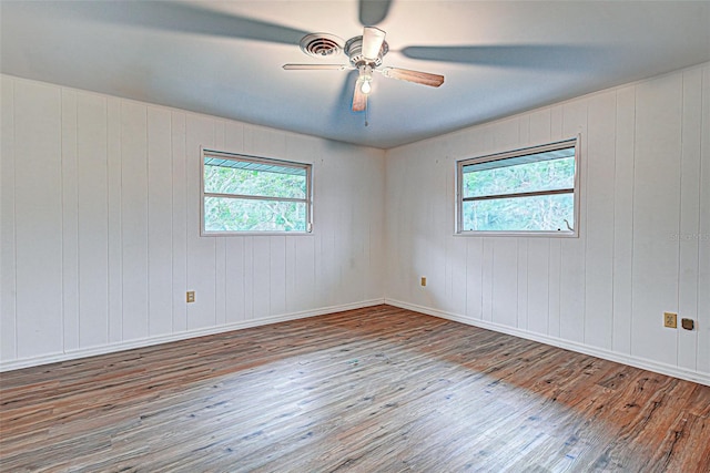 spare room featuring ceiling fan and dark hardwood / wood-style flooring