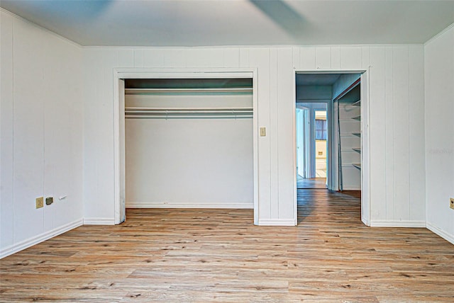 unfurnished bedroom featuring a closet and light wood-type flooring