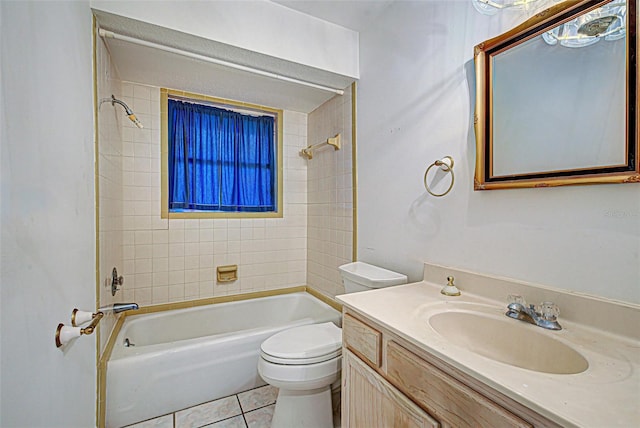 full bathroom with vanity, tile flooring, toilet, and tiled shower / bath