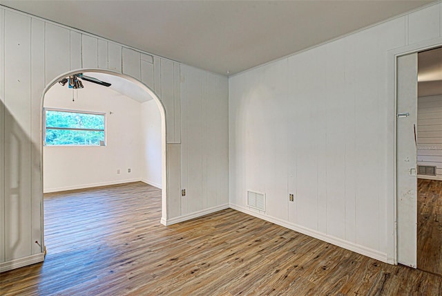 unfurnished room with ceiling fan and dark hardwood / wood-style flooring