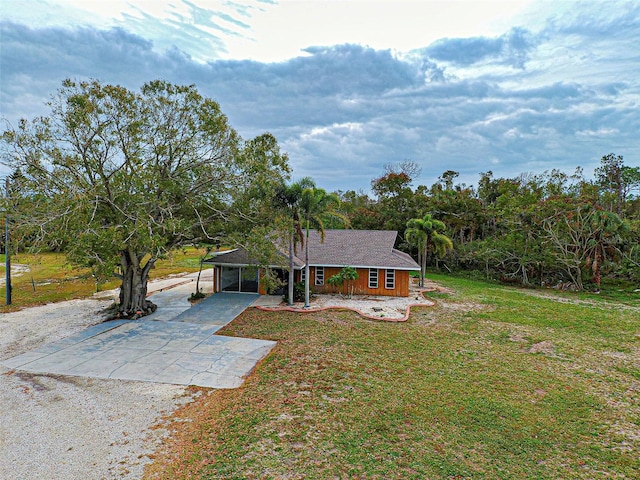 view of front of house with a front lawn and a carport