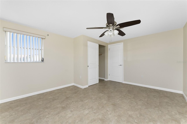 tiled spare room with ceiling fan