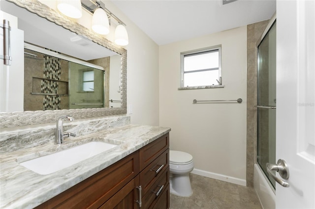 full bathroom featuring enclosed tub / shower combo, tile floors, vanity, and toilet