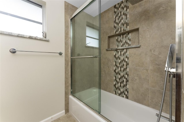 bathroom featuring combined bath / shower with glass door