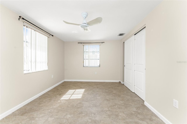 spare room featuring ceiling fan and light tile floors