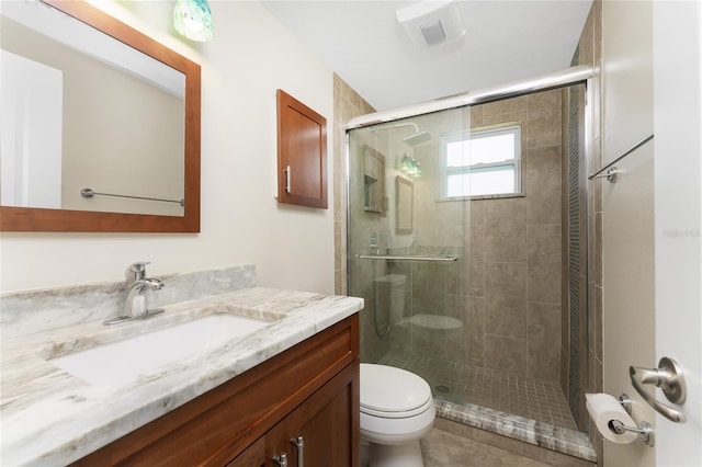 bathroom featuring an enclosed shower, toilet, and vanity