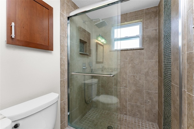 bathroom with an enclosed shower and toilet