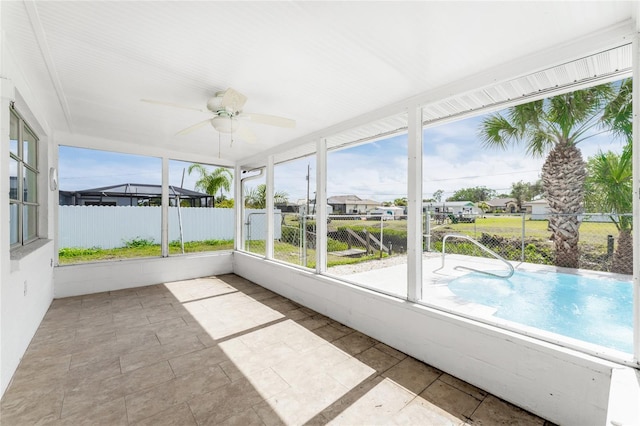 unfurnished sunroom with ceiling fan