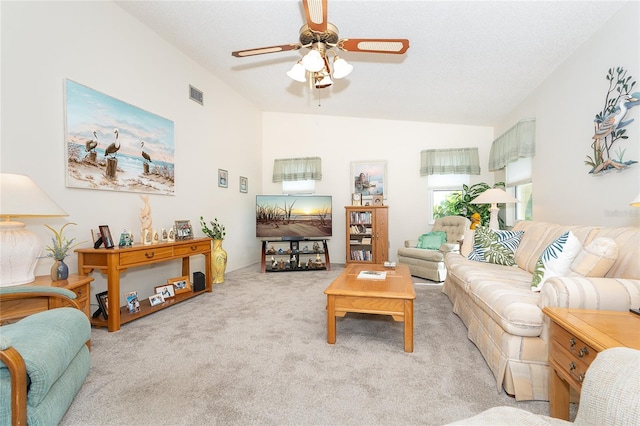 carpeted living room featuring vaulted ceiling and ceiling fan