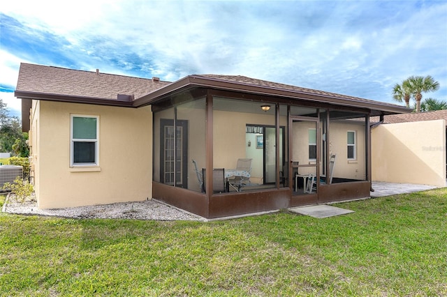 rear view of property featuring a lawn, a patio, and central air condition unit