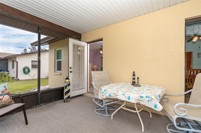 sunroom featuring wood ceiling, ceiling fan, and beamed ceiling