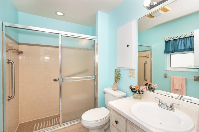 bathroom with toilet, tile flooring, walk in shower, and vanity