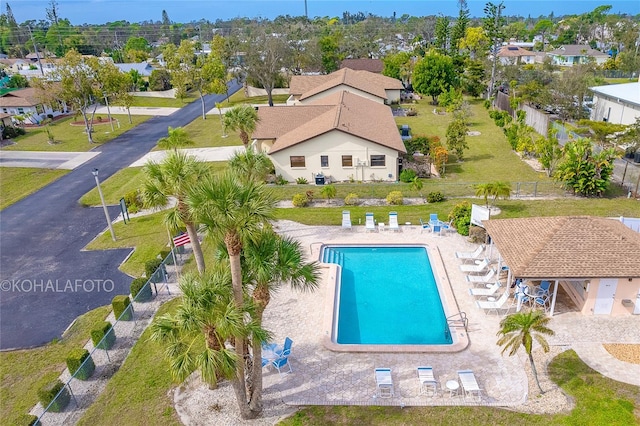 view of pool featuring a patio and a yard