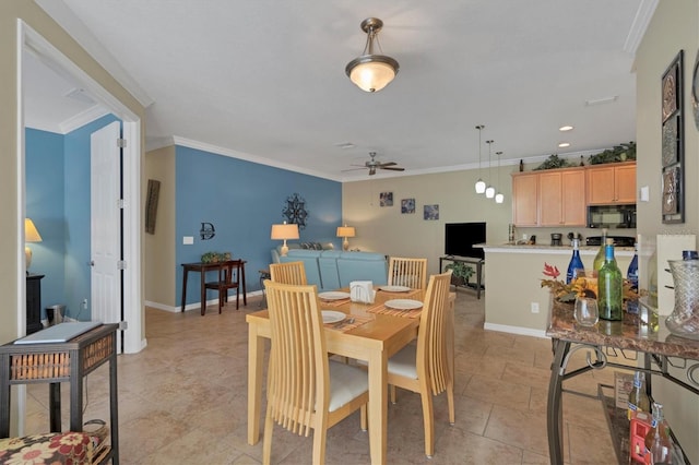 tiled dining area with ornamental molding and ceiling fan