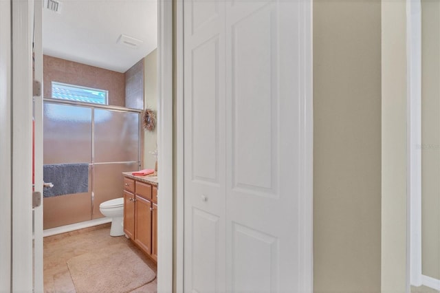 bathroom featuring toilet, tile floors, and vanity