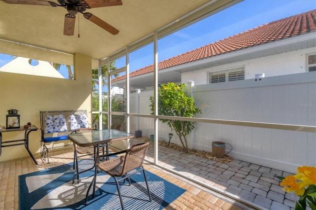 sunroom featuring ceiling fan