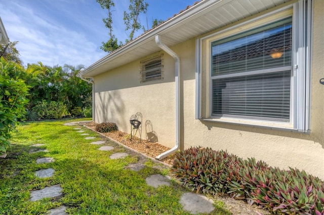 view of side of home featuring a lawn