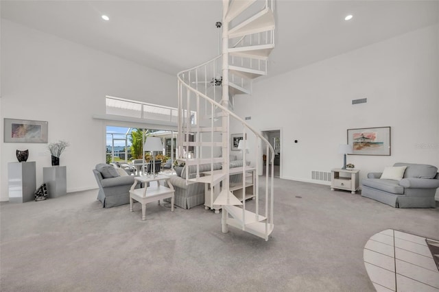 living room featuring carpet and a high ceiling