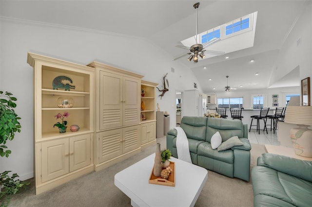 living room featuring ceiling fan, light colored carpet, vaulted ceiling, and ornamental molding