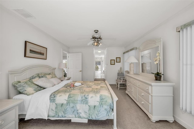 bedroom with multiple windows, ceiling fan, and light colored carpet