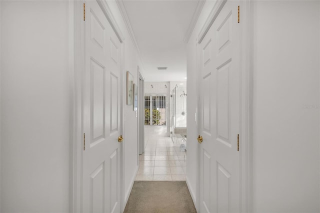 corridor with crown molding and light colored carpet