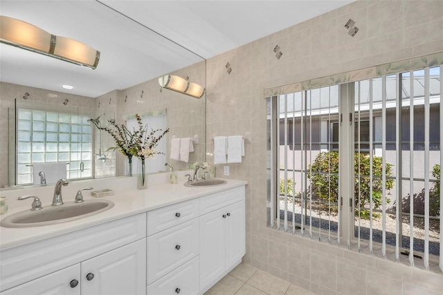 bathroom with tile patterned floors, vanity, and tile walls