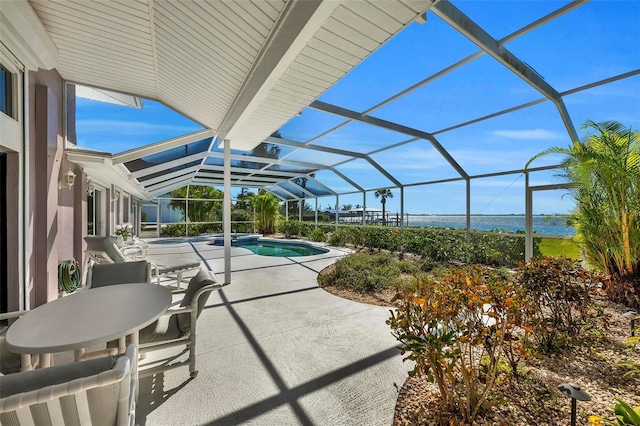 view of patio / terrace with a water view and glass enclosure